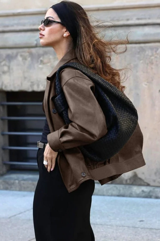 Double-breasted black leather coat with lapel collar 