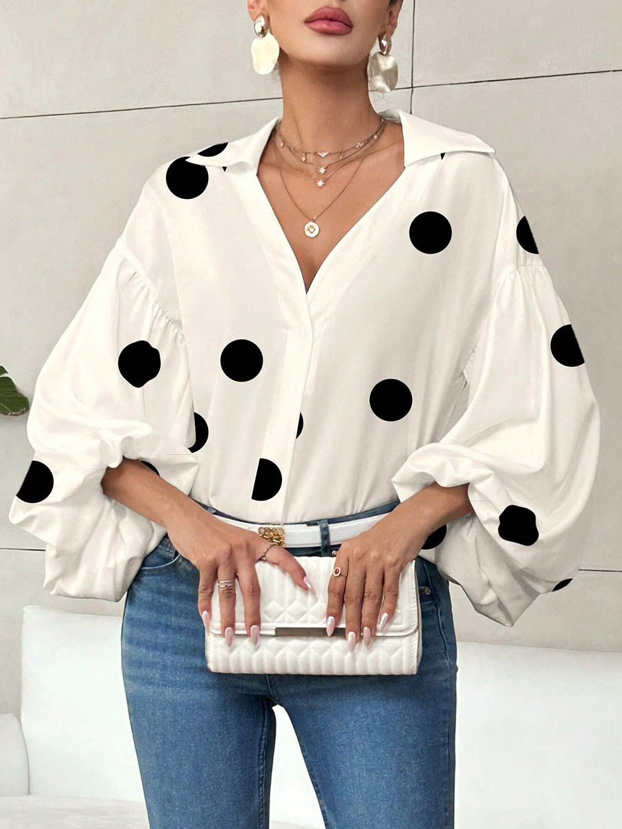 Detailaufnahme von Plissee, Reverskragen und Polka-Dot-Muster der Bluse