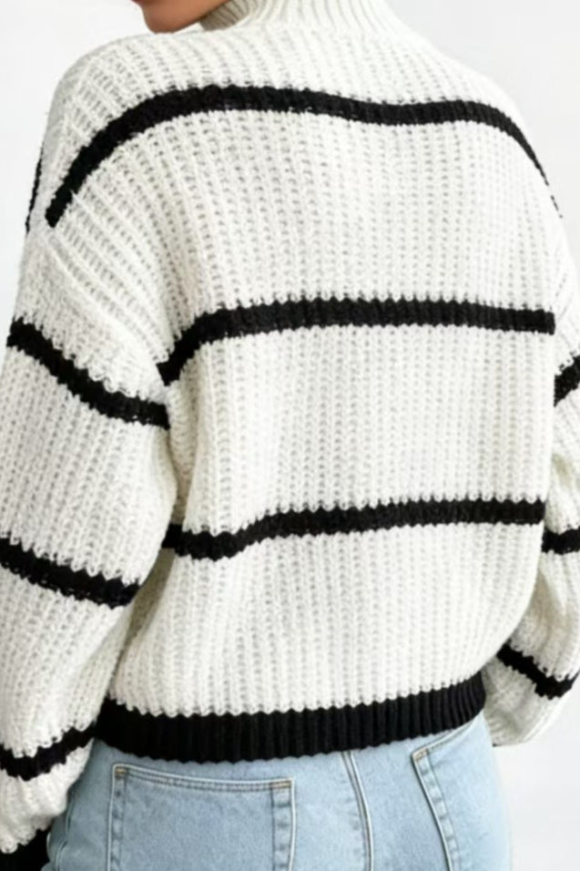 Detailansicht der Strickstruktur und Kontraststreifen des Pullovers